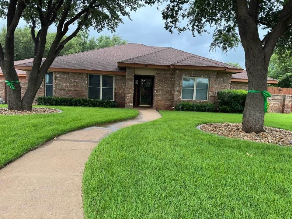 Freshly mowed lawn with clean edging at an Abilene-area property